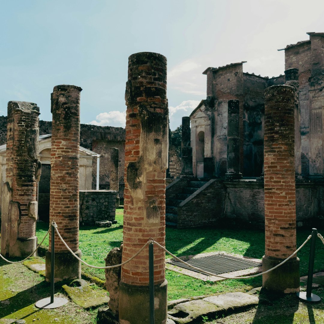 Brick columns and roped-off remains of a sanctuary inside the Pompeii archaeological park